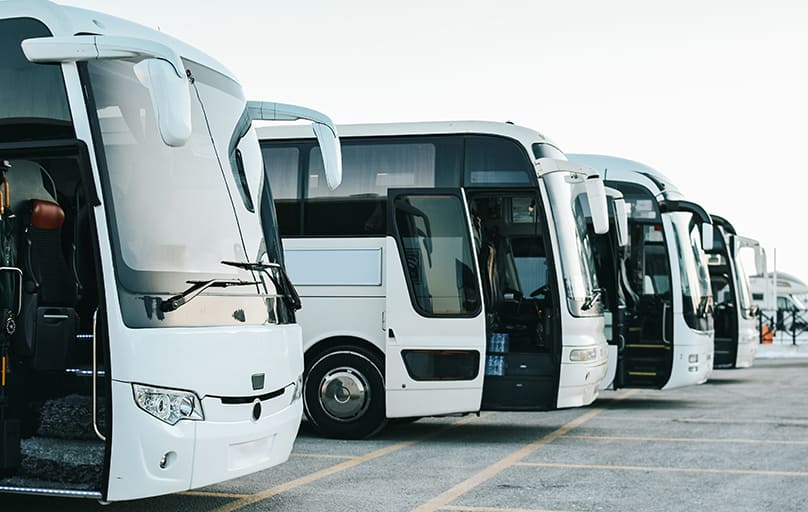 a fleet of new charter busses with open doors